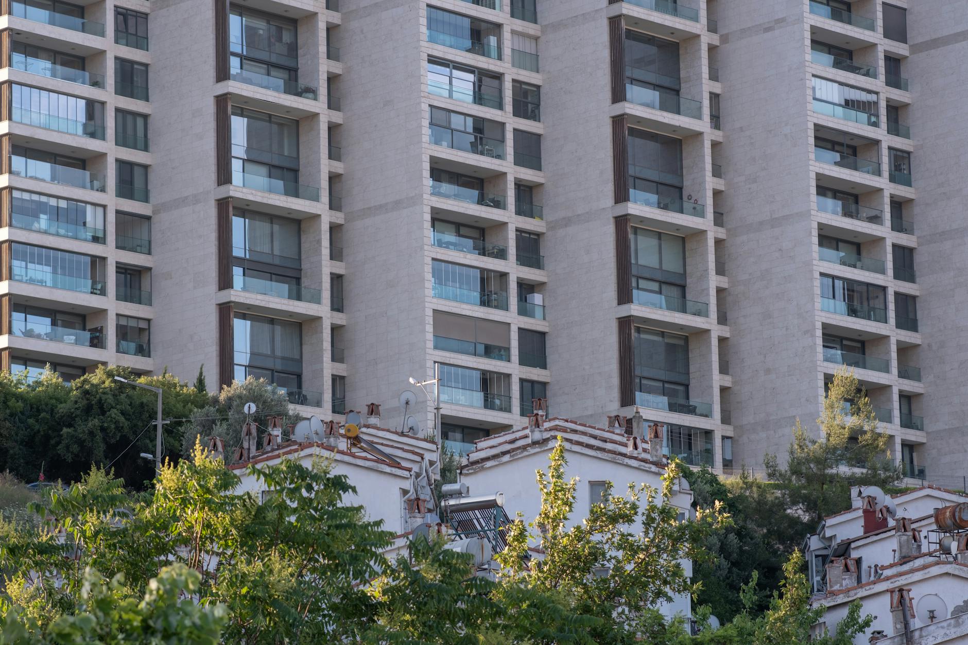 High-rise residential building facade with trees in Bornova, İzmir.