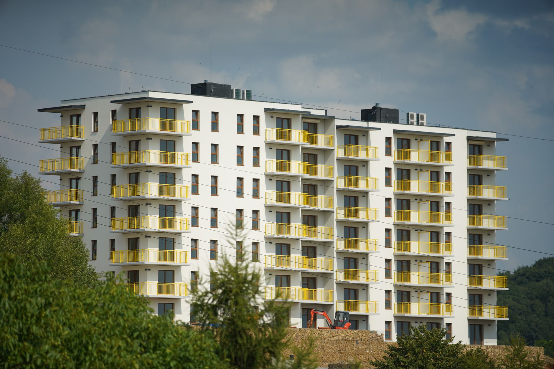 Photography of a modern apartment building with yellow balconies in Trzebinia, Poland