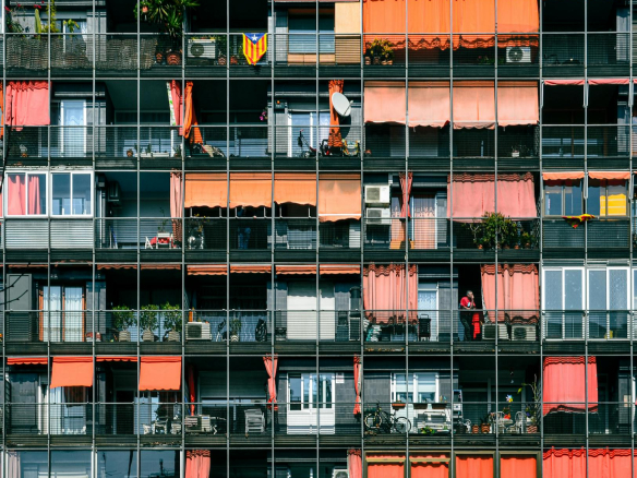 A colorful and dynamic facade of modern apartments in Barcelona, Spain.