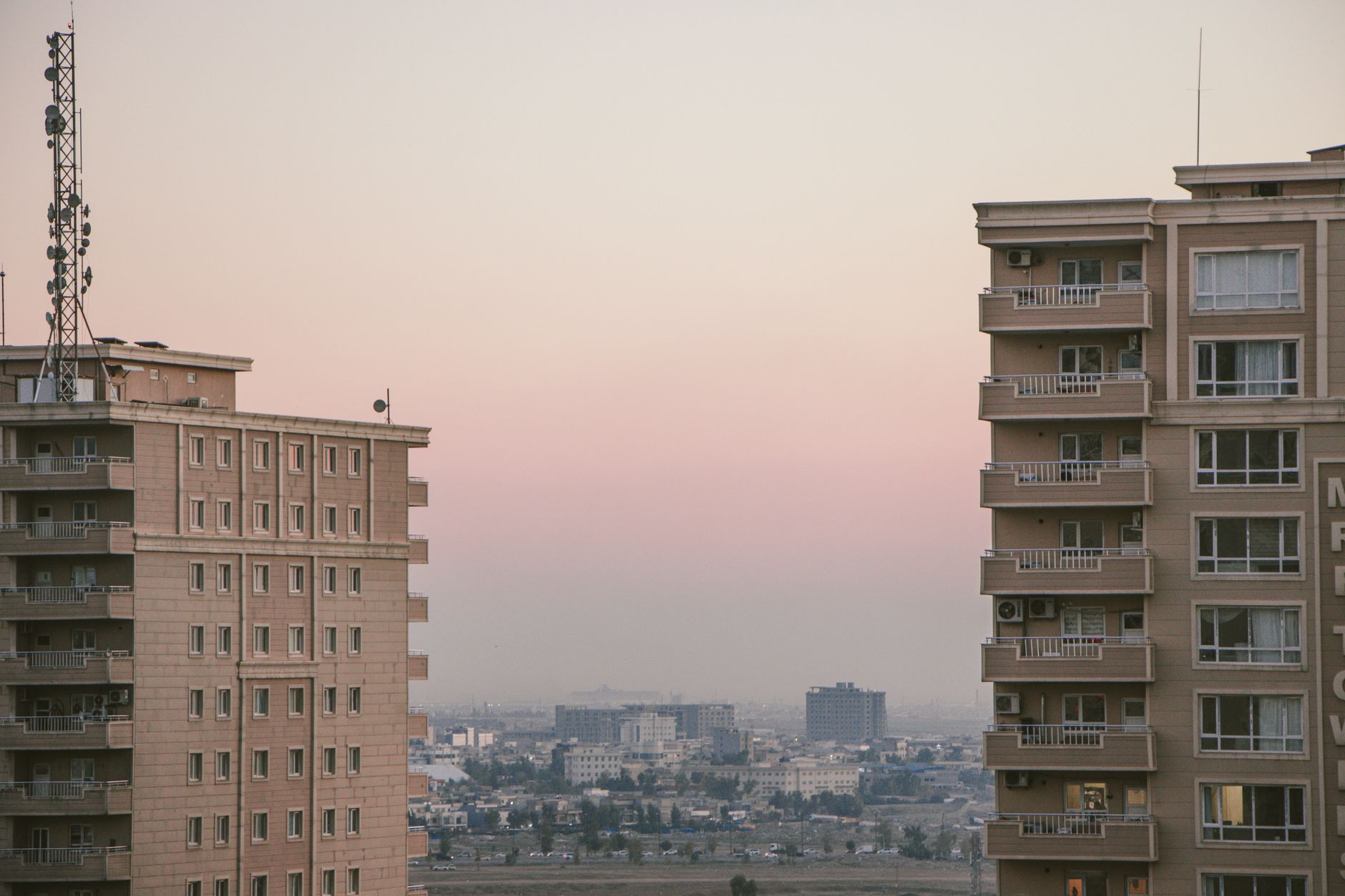 Scenic view of city skyline with high-rise buildings during a serene dusk.