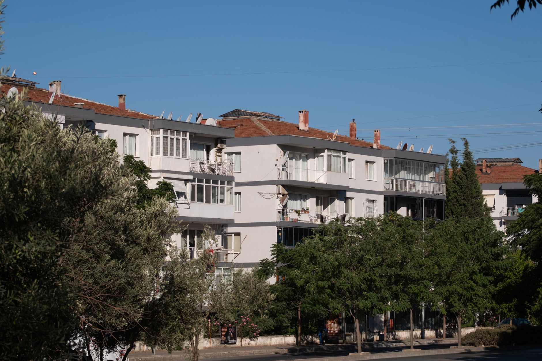 View of residential apartments with sunny sky in Izmir, Turkey's urban area.
