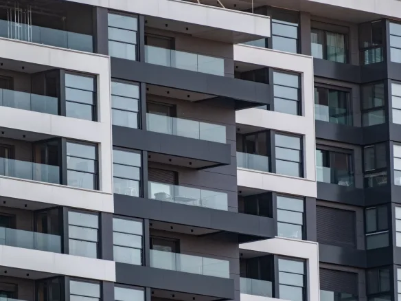 Contemporary apartment facade with glass balconies in Bornova, İzmir, Türkiye.